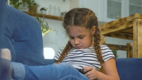 Child tablet game. People lifestyle.child is sitting on sofa, playing game on digital tablet.little girl is watching cartoon on laptop. Modern children, educational technologies. 3D Illustration