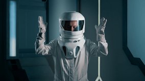 The astronaut removes his helmet aboard the spacecraft. A portrait of an astronaut in a sealed suit looks into the camera. Astronaut Mission - Powered by Shutterstock - Get 15% off with code: PIKWIZARD15