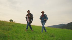 African american woman and caucasian man tourists hiking on mountains. Cheerful active healthy sports couple traveling on summer forest adventure outside. - Powered by Shutterstock - Get 15% off with code: PIKWIZARD15