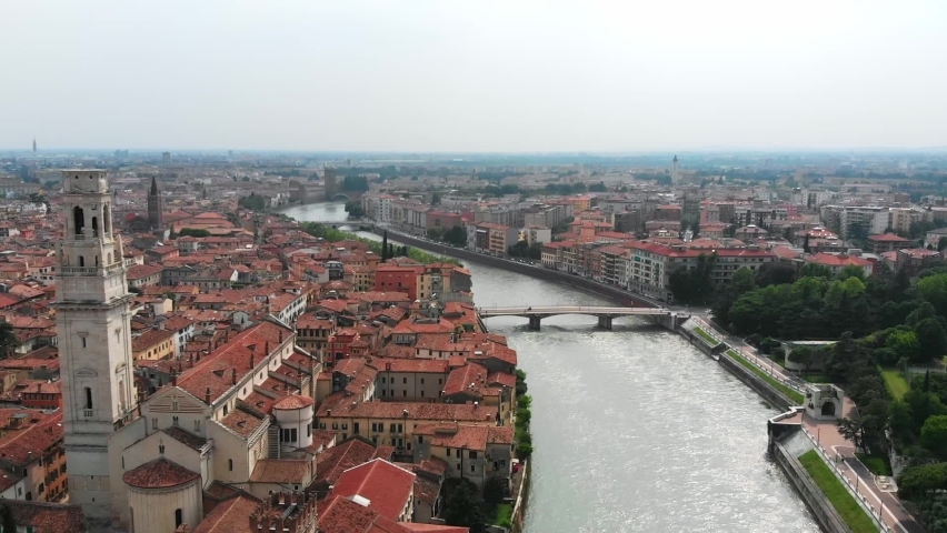 Panoramic drone view of Verona, Italy. Aerial 2k footage of Piazza Isolo, Veronetta, Pontepietra bridge and Adige river. Torricelle, Roman Theater, cathedral and walls surrounding the medieval city. Royalty-Free Stock Footage #1094462445