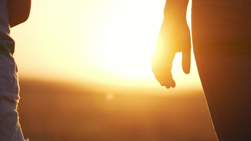 happy family. mom and daughter hold hands close up. mother and baby girl hands together at sunset. parent girl and child happy childhood. lifestyle happy family mothers day together concept Royalty-Free Stock Footage #1094463649