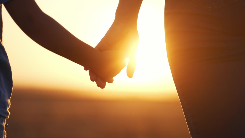 Happy family. mom and daughter hold hands close up. mother and baby girl hands together at sunset. parent girl and child happy childhood. lifestyle happy family mothers day together concept | Shutterstock HD Video #1094463649