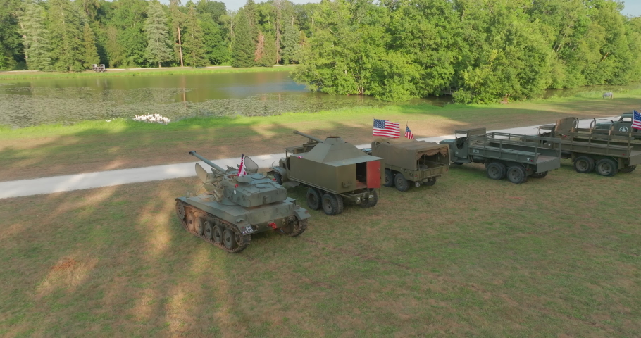 Aerial view. Convoy of old American military vehicles. Exhibition of old USA army weapons and equipment. Top view