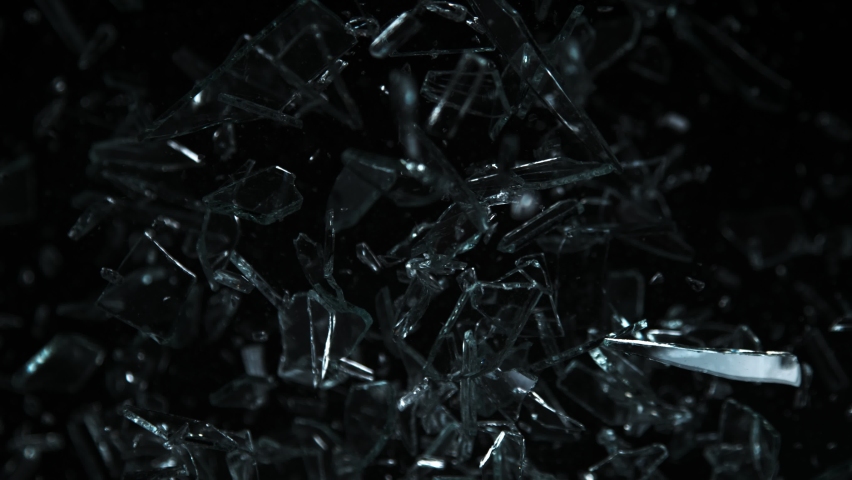 Super Slow Motion Shot of Glass Shards Flying Towards Camera Isolated on Black at 1000fps. Royalty-Free Stock Footage #1094469241