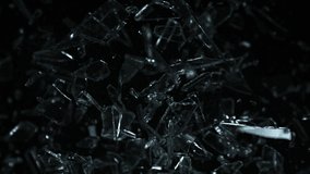 Super Slow Motion Shot of Glass Shards Flying Towards Camera Isolated on Black at 1000fps. - Powered by Shutterstock - Get 15% off with code: PIKWIZARD15