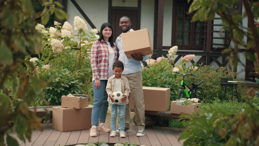 Portrait of a multi-ethnic family during a move to a new home. African dad, Caucasian mom, african son.Multiracial Family,Mixed Race,Diverse People,Multiethnic Relations Royalty-Free Stock Footage #1094472735