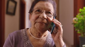 Senior woman, phone call and communication in house living room or home interior. Smile, happy or talking elderly in retirement on technology for funeral insurance, investment savings or pension loan - Powered by Shutterstock - Get 15% off with code: PIKWIZARD15