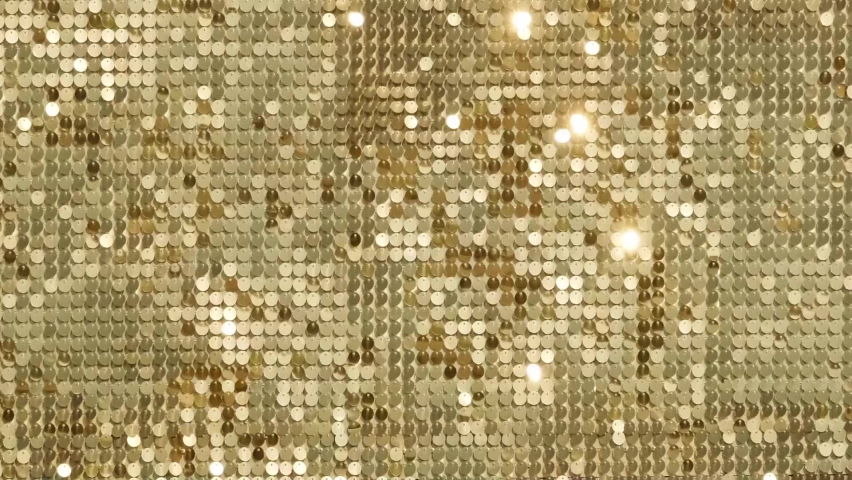rows of blinking golden yellow brass metal plaques sway in wind and shines in sun and create unique pattern of movement. round reflective particles texture glitter under waves of wind. Spangle Glitter Royalty-Free Stock Footage #1094483959