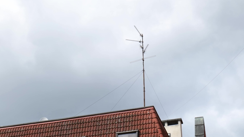 One single old TV antenna, classic vintage TV aerial placed on top of a building in the city, detail, closeup, nobody Over the air broadcast, radio broadcasting abstract concept, no people