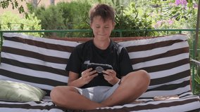 teen plays a game on a gadget