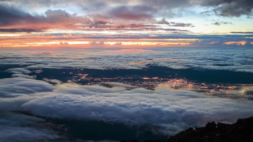 Timelapse: Sunrise view from top of Mt. Fuji as clouds move over landscape
