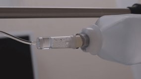 Vertical video. Closeup of medical dropper in the hospital ward, intravenous treatment with drugs in clinic