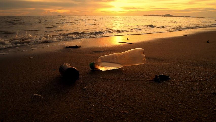 Plastic bottles garbage on sand beach is environment pollution of global with sunset sky background. Royalty-Free Stock Footage #1094506327