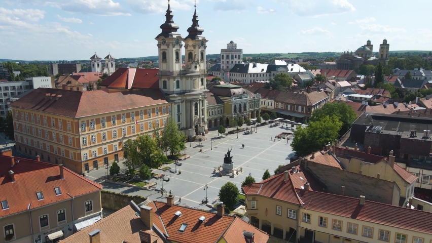 Wide establishing shot of the Church of Anthony of Padua in Hungary with people walking past