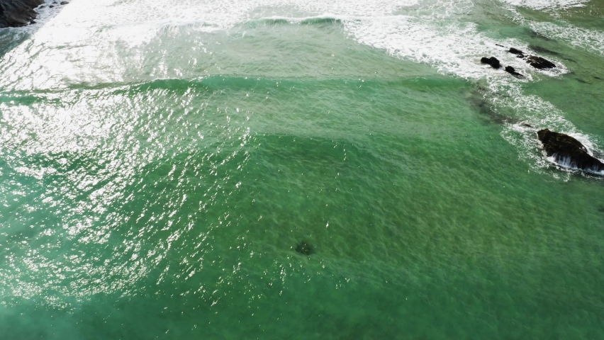 Ocean Waves Coming to The Shore Of Lusty Glaze Beach At Summer In Newquay, UK. - aerial