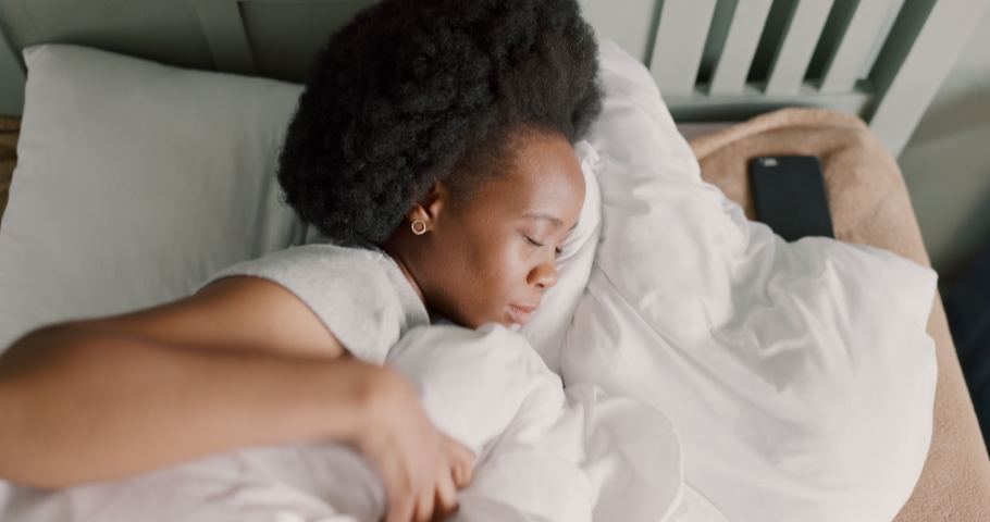 Bedroom, insomnia and girl with sleep problem or mental health difficulty trying to rest in home. Frustrated, moody and unhappy black woman with struggle to relax in position on pillow. Royalty-Free Stock Footage #1094518483