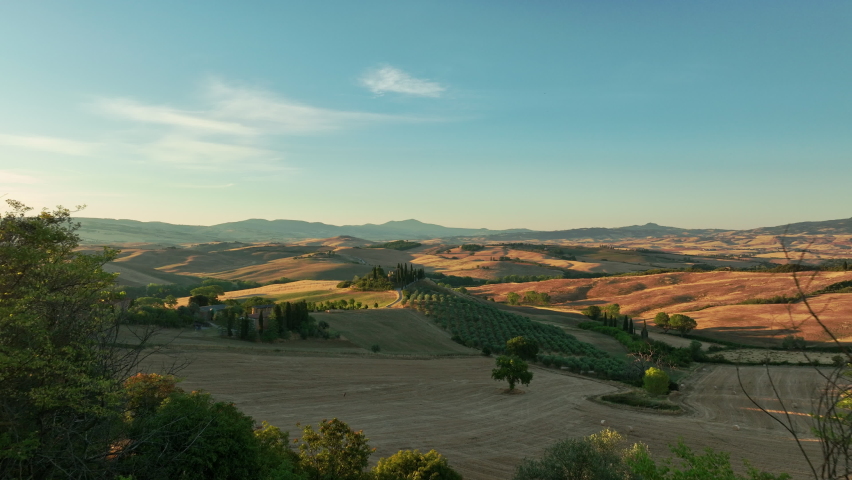 Aerial view of the Val D'Orcia during a beautiful sunrise. Val D'Orcia is  a wide and beautiful countryside in southern Tuscany.  Royalty-Free Stock Footage #1094519315