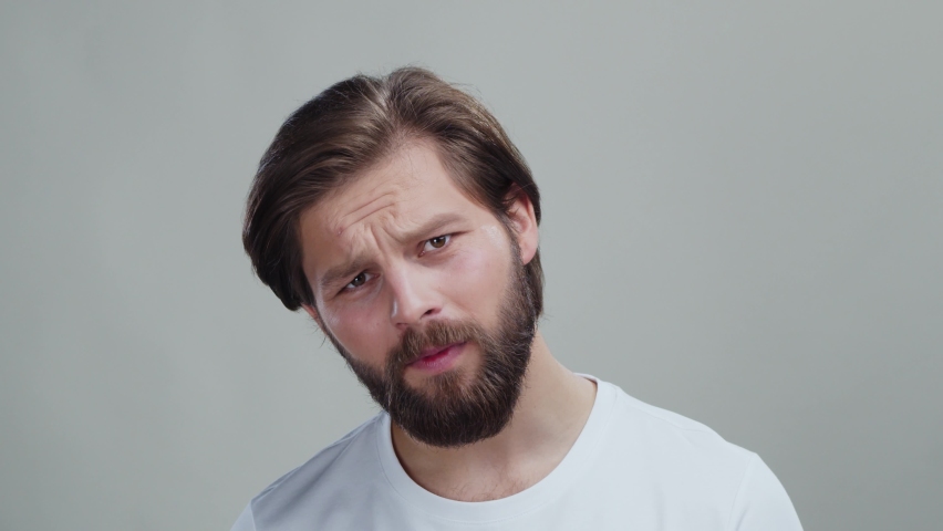Stressful bearded caucasian male looking into mirror overlooking pimples getting upset of having skincare problems. Acne concept. Healthcare. | Shutterstock HD Video #1094521459