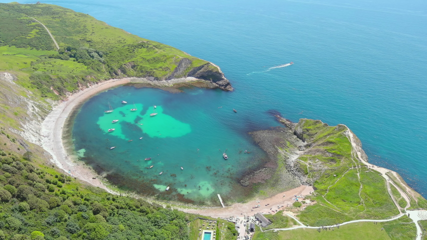 Lulworth Cove, UK: Aerial view of picturesque cove on Jurassic Coast - landscape panorama of United Kingdom from above
