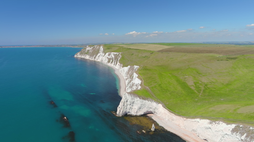 Aerial view of white limestone cliffs near Durdle Door on Jurassic Coast - landscape panorama of United Kingdom from above