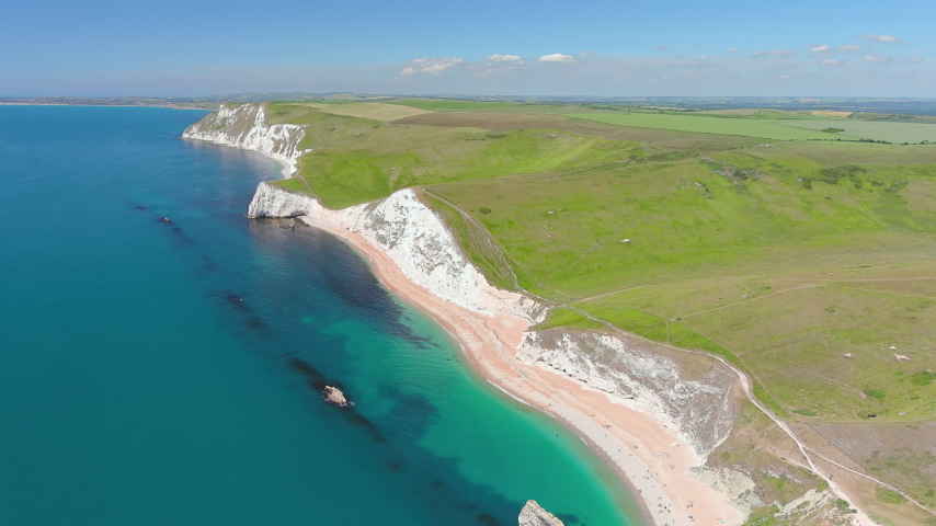 Aerial view of white limestone cliffs near Durdle Door on Jurassic Coast - landscape panorama of United Kingdom from above
