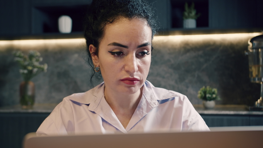 Caucasian serious woman freelancer with worried frustrated face because mistake that happened, working on laptop, sitting in office, using laptop, working on laptop. Concept of online work at home. Royalty-Free Stock Footage #1094533273