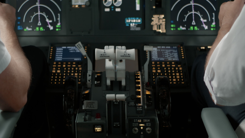 DOLLY IN Commercial aircraft pilots controlling airplane throttle lever during the flight or take off. View from inside the cabin. Real aircraft, daytime shot | Shutterstock HD Video #1094534293