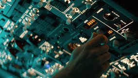 CU Commercial aircraft pilot adjusting flight parameters of the plane during the flight at high altitude. View from inside the cabin. Real aircraft, nighttime shot - Powered by Shutterstock - Get 15% off with code: PIKWIZARD15