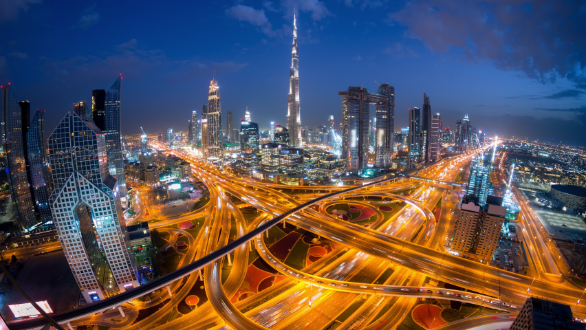 Night Time lapse of car light traffic in conjunction interchange high rise futuristic building in Dubai  from top view with wide angle. Royalty-Free Stock Footage #1094536751