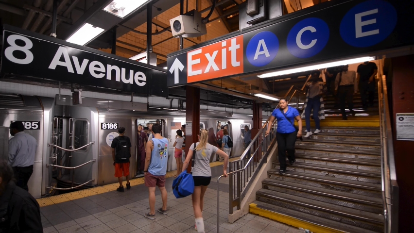 NYC, USA - SEPT 2, 2013: subway station crowded people stairs entering exiting train platform New York City.