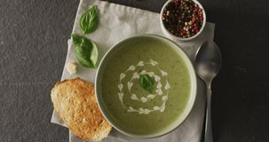 Video of green peas soup and ingredients lying on grey surface. American cuisine, meal, food and cooking concept.