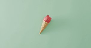 Video of cone with ice creams lying on green surface. Food, meal, sweets, cuisine and cooking concept.