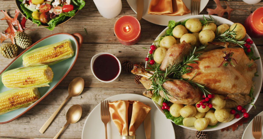 Video of tray with roasted turkey and diverse dishes on wooden surface. Thanksgiving, american culture, tradition and celebration video.