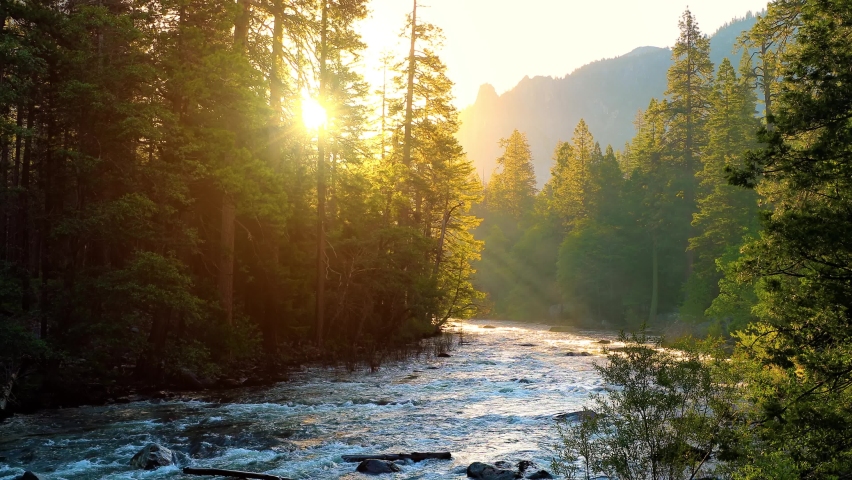 Beautiful morning shot of the sun shining on the Merced River as it runs through Yosemite National Park in California. | Shutterstock HD Video #1094546561
