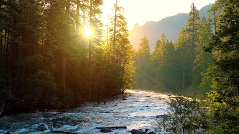 Beautiful morning shot of the sun shining on the Merced River as it runs through Yosemite National Park in California.の動画素材