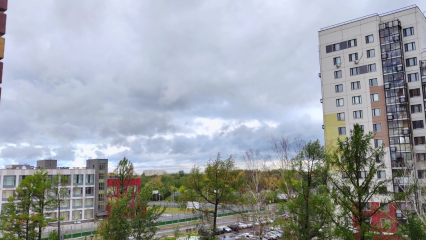 Timelapse of heavy clouds moving over city. Royalty-Free Stock Footage #1094556419