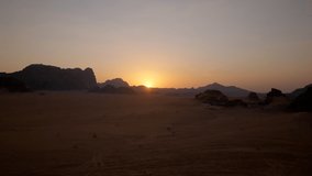 Time-lapse of a beautiful sunset in Jordan desert of Wadi Rum with the red rocks in the background - Powered by Shutterstock - Get 15% off with code: PIKWIZARD15