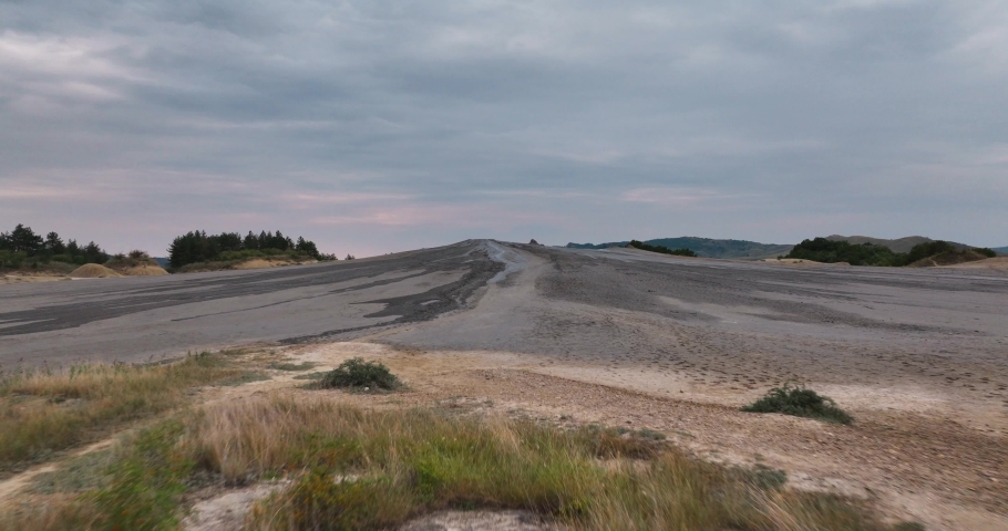 Aerial view of a geological and botanical reservation with mud volcanoes on a sunny day.