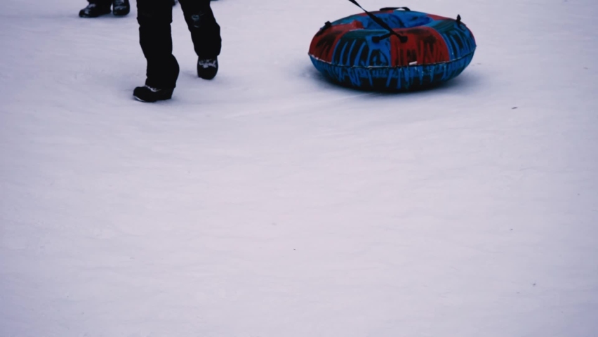 Bottom view. Children pull snow tubing, sled, winter sport, activity Royalty-Free Stock Footage #1094562157