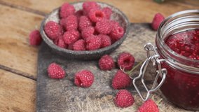 Raspberry jam in a jar with fresh berries. Sweet food. Tasty dessert. 4k video
