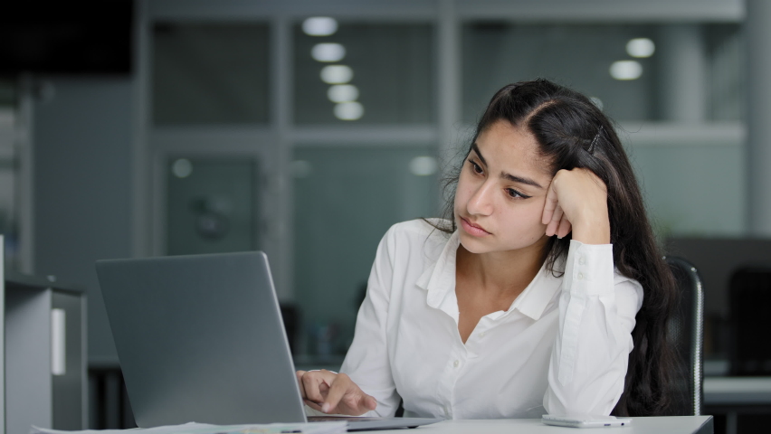 Sad bored lazy young woman typing on laptop tired unmotivated businesswoman office worker feels fatigue from working at computer suffers from overwork distracted from boring dull job feeling exhausted | Shutterstock HD Video #1094566567