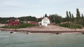 Historic Point Betsie Lighthouse in Frankfort, Michigan located along Lake Michigan with drone video flying overhead.