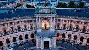Vienna at night, aerial night view of the capital of Austria, classic royal palace of Hofburg with night illumination, downtown Vienna after sunset, tourism in Austria. High quality 4k footage