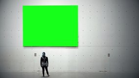 Girl Looking Up Panel Green Screen On Wall. Woman looking up to a green screen panel hanging on a building wall. - Powered by Shutterstock - Get 15% off with code: PIKWIZARD15