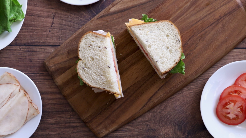 Eating a Turkey Sandwich with Tomato and Lettuce | Shutterstock HD Video #1094581761