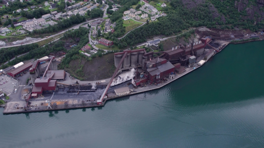 Plant on the shore of a picturesque fjord in norway aerial view chemical production mining