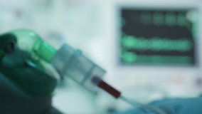 A female patient in medical mask is breathing oxygen support in a hospital with ecg heart rate machine. Unhealthy woman in coma. Getting mechanical ventilation. Concept of pandemic and therapy - Powered by Shutterstock - Get 15% off with code: PIKWIZARD15