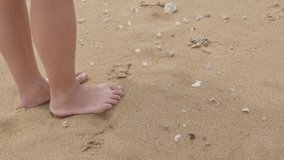 close up view to A young asian woman's foot while walking on the beach and relax while on holiday vacation