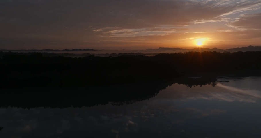 Aerial landscape of sunrise in the rural river hill clouds reflection in the water at Sichuan China