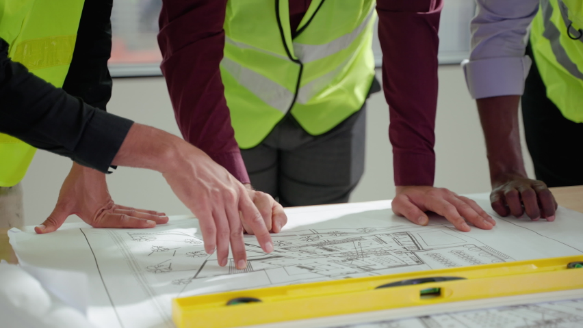 civil engineering team Along with the architect and foreman watching the Blue Print and planning the construction of the building on the construction site. Royalty-Free Stock Footage #1094602093